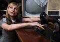 woman posing with vintage tv and sewing machine